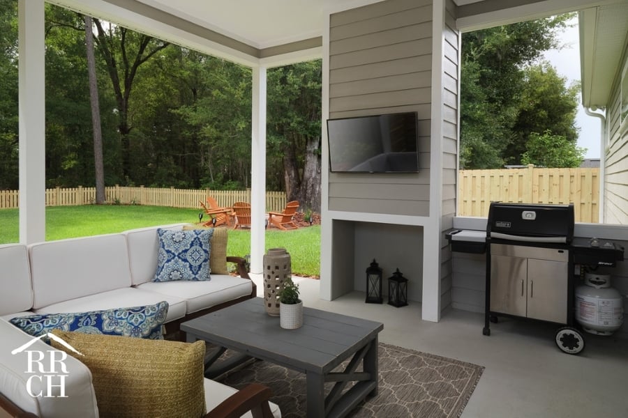 Custom Home Build Longleaf Outdoor Living Area with TV and Grill | Robinson Renovation & Custom Homes, Inc.