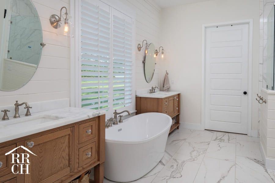 Custom Home Build Master Bathroom Modern Farmhouse Style Freestanding Tub His and Hers Vanities Shiplap Walls - Dylans Grove 2 | Robinson Renovation & Custom Homes, Inc.