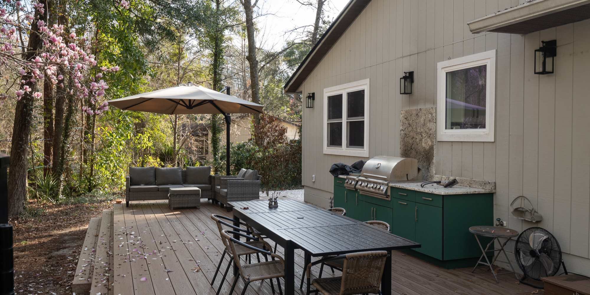 Custom outdoor living space in Gainesville with built-in grill and dining setup by Robinson Renovation