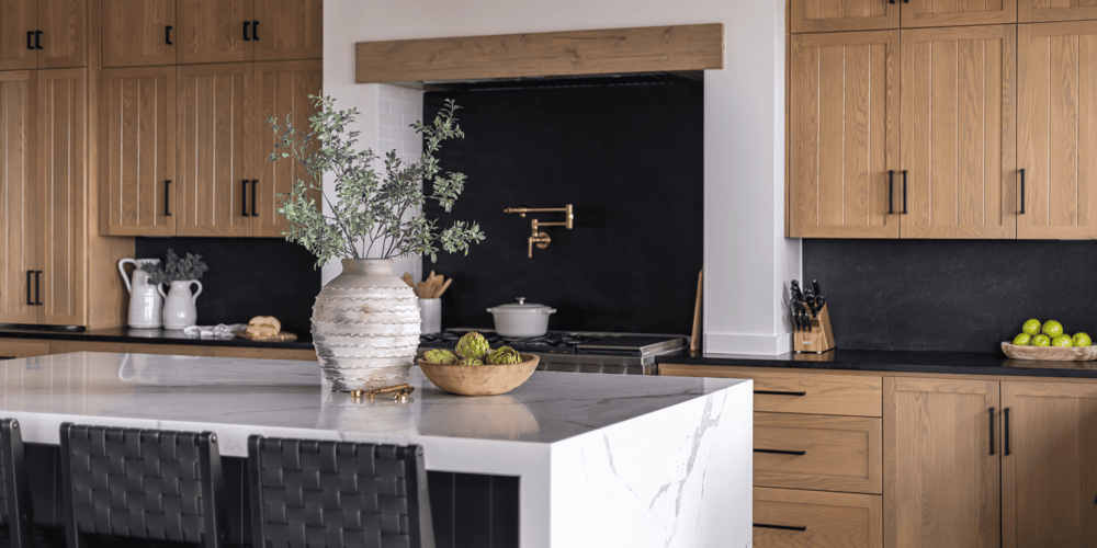 Stock Image of Kitchen Remodel with Black Countertops and Marble Island