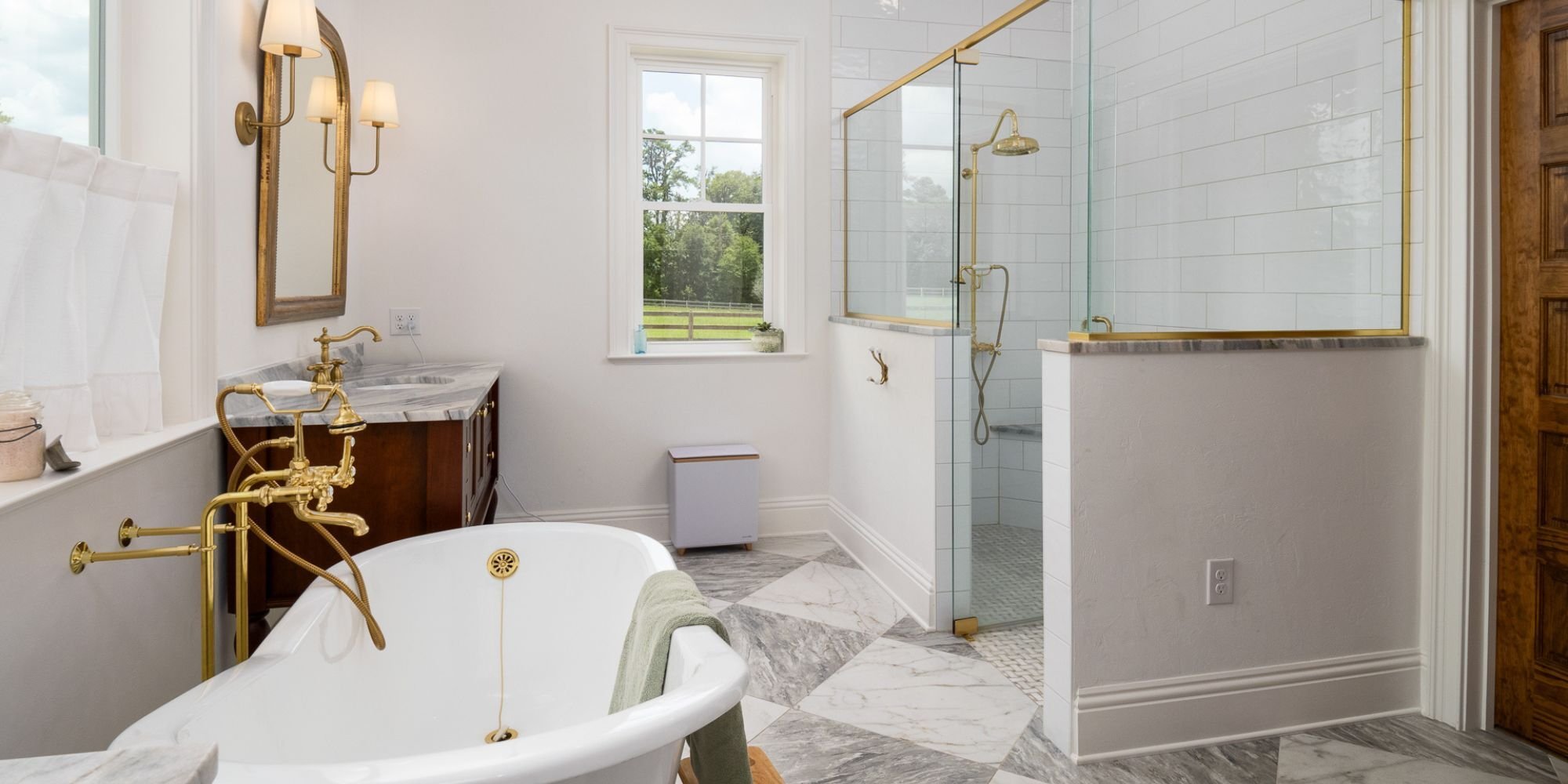 Custom bathroom remodel in Alachua County by Robinson Renovation & Custom Homes featuring an oversized walk-in shower, standalone soaking tub, and gold plumbing fixtures