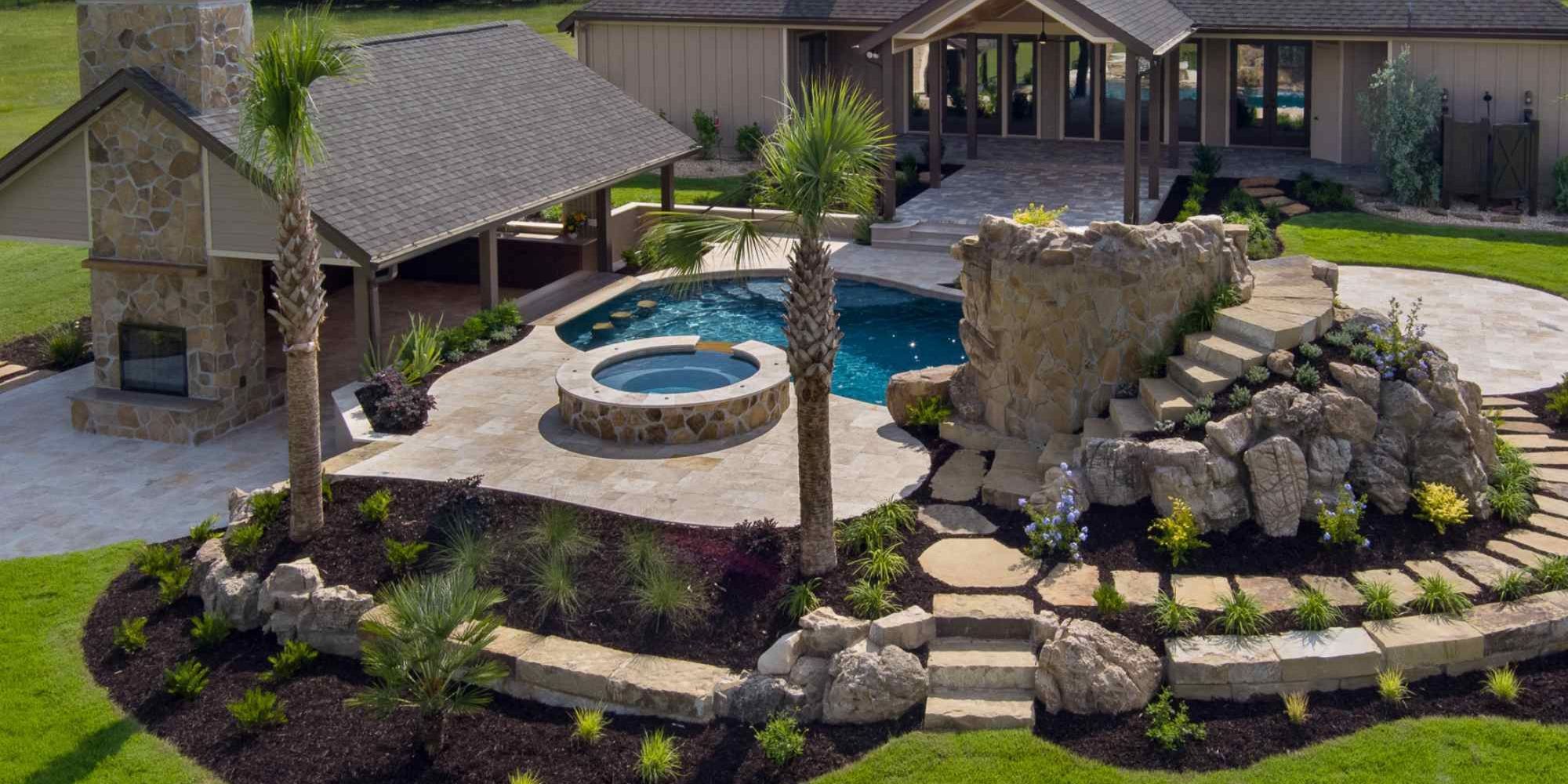 Outdoor living space with a pool and stone feature in Alachua County, FL by Robinson Renovation & Custom Homes