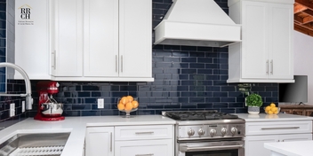 Gainesville kitchen remodel with white cabinetry, dark blue subway tile backsplash, stainless steel range, and white countertops