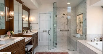 Image of a walk-in glass shower and double vanity in a remodeled bathroom in Gainesville, FL