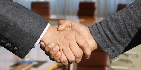 Two men shaking hands at an interview for an engineering position in Gainesville