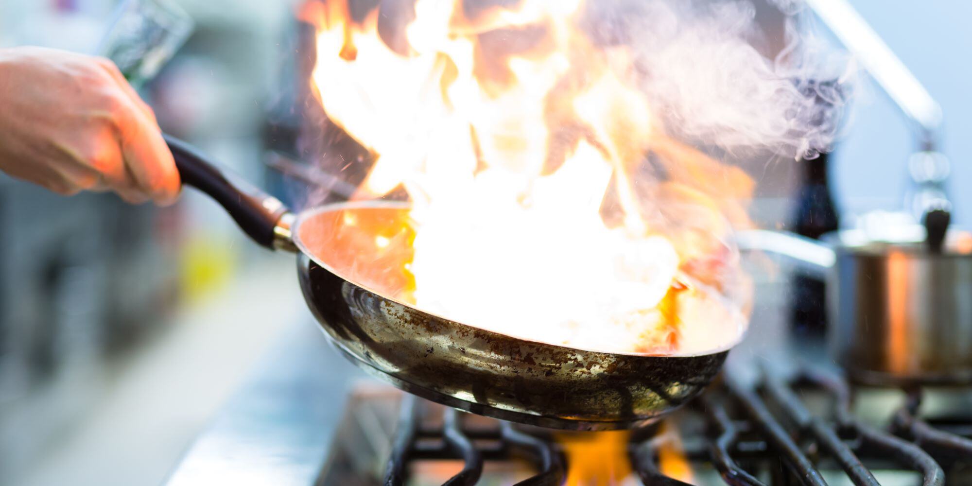 Image of Pan on Fire on Stove - reasons to have outdoor kitchen - Robinson Renovations - Gainesville Fl Design Build Remodeler and Custom Home Builder