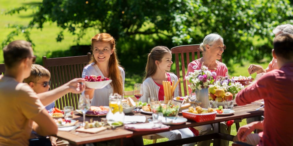 Outdoor Dining Table with Family Gathered for Entertaining