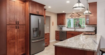 A kitchen remodel as part of a whole home remodel with warm wood cabinetry and quartz countertops in Gainesville, FL by Robinson Renovation & Custom Homes