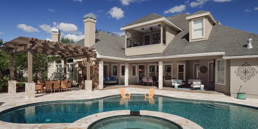 Backyard of custom home in Alachua County, FL with pool, hot tub, and pergola