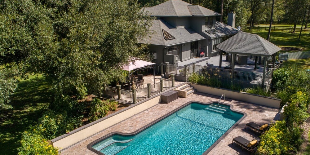 Outdoor Living Space in Gainesville with Kitchen, Pool, and Seating