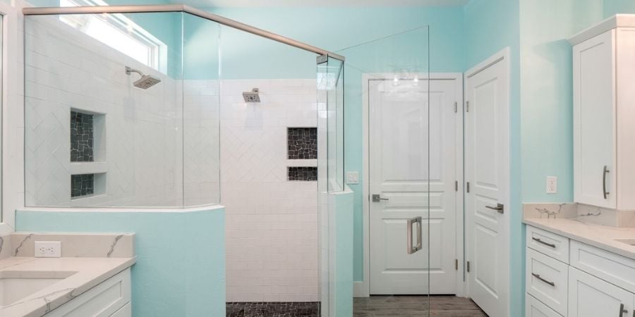 light blue and white bathroom with storage niches