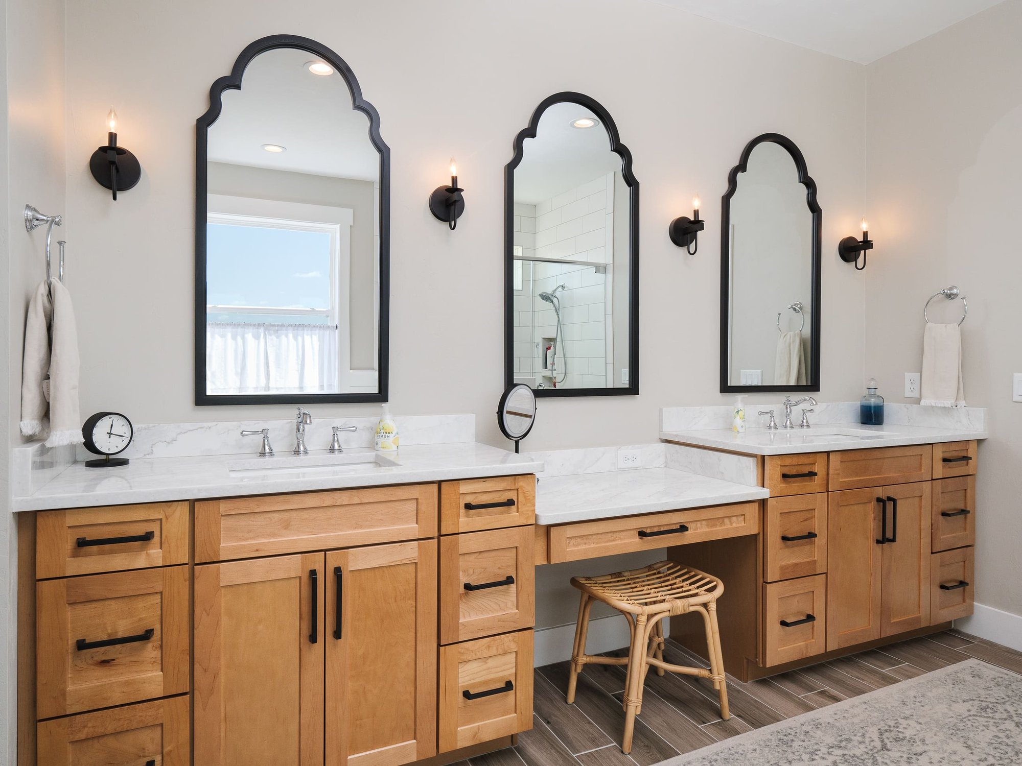 Modern bathroom with dual wood vanities and arched mirrors - Timeless Custom Home Design Trends in Gainesville, Florida - Robinson Renovations - Custom Home Builder