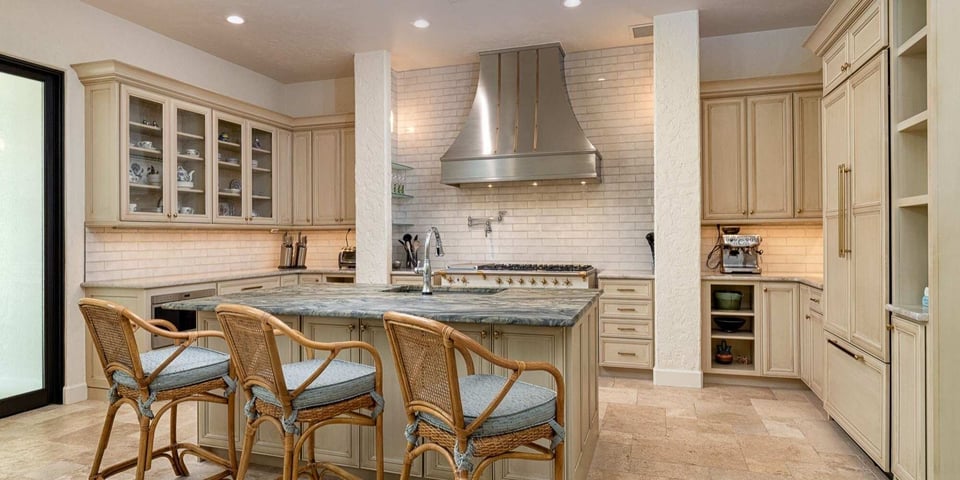 Alachua County FL kitchen remodel by Robinson Renovation and Custom Homes with cream cabinetry and large range hood