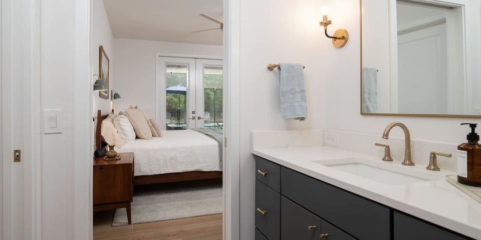 Robinson Renovations’ gold faucet & marble bathroom design – Gainesville FL custom builder with 2025 remodeling style trends