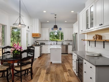 Image of a remodeled kitchen with dining area and white cabinets by RRCH in Gainesville, FL